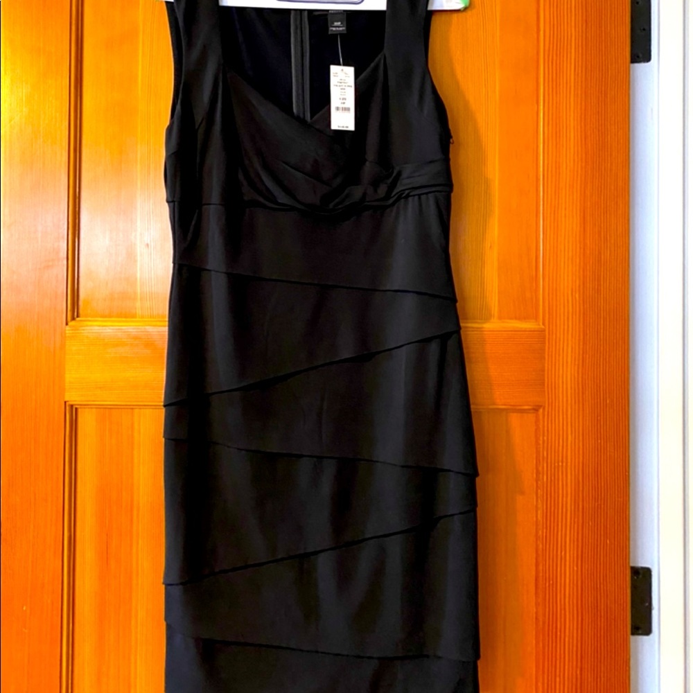 Beautiful fitted black dress.  Never worn very comfortable material.